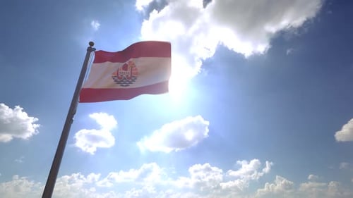 French Polynesia Flag Waving Against Bright Sunny Sky