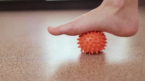 Foot Rolling on Spiky Massage Ball