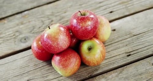 Red apples arranged on wooden plank