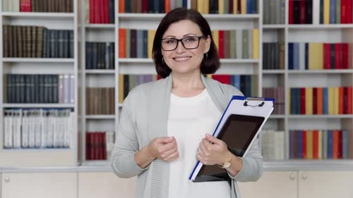 Professional Woman Smiling in Front of Bookshelf