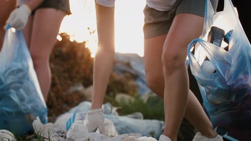 Close Up Shot of Group of Eco Volunteers Cleaning Up Area of Dump Near the Field Slow Motion
