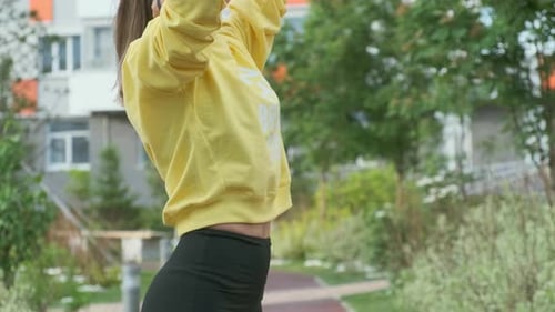 Beautiful Sporty Woman Exercises on Street