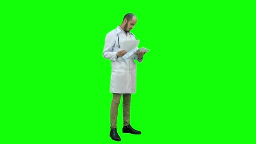 Male Doctor Checking Medical Documents on a Green Screen, Chroma Key