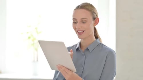 Portrait of Video Call on Tablet By Woman in Office