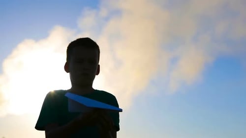 Child Launches Paper Airplane Toward Sunny Sky