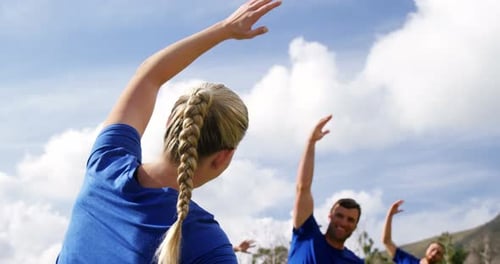 Female trainer training people in boot camp 4k