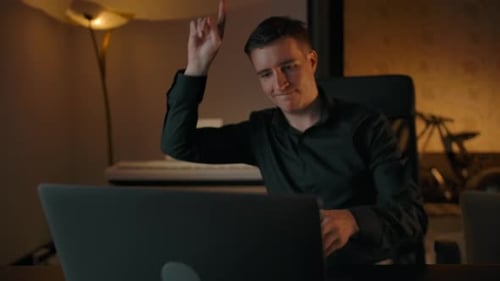 Young Adult Using Laptop and Celebrating Success