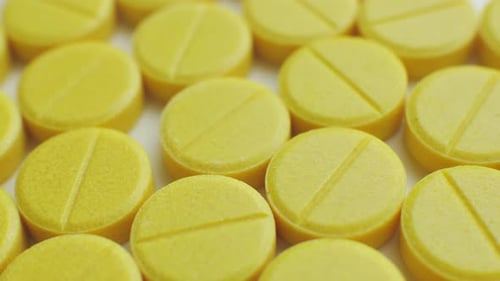 Macro Shot of Array of Yellow Pills