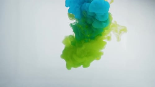 Colorful Blue and Green Ink Mixing in Water