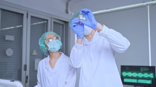 Scientists Inspecting Vial in Bright Laboratory