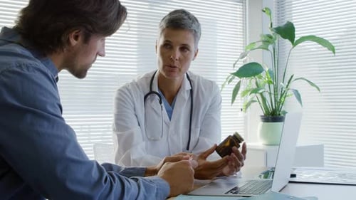 Doctor Explains Medication to Patient in Office