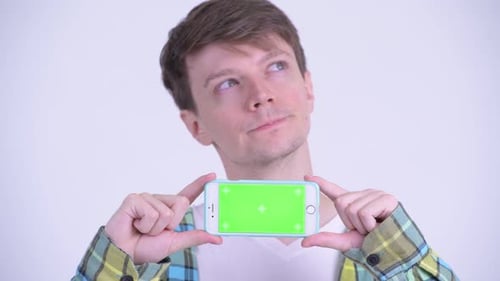 Young Man Holding Phone With Green Screen Display