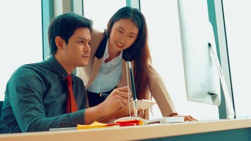 Two Business People Talk Project Strategy at Office