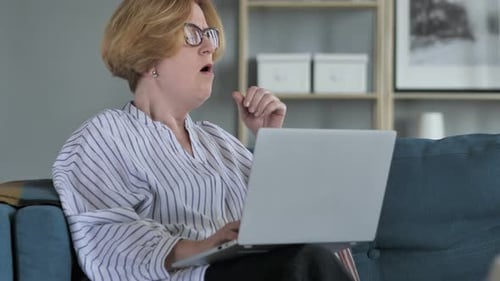 Woman Working on Laptop Coughing