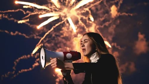 Woman with Megaphone Shouting at Fireworks Display