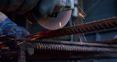 Close-up Slow Motion. Side View of Male Hands Cutting Metal with Grinding Machine. V2