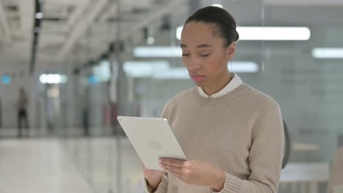 African Woman Using Tablet in Office