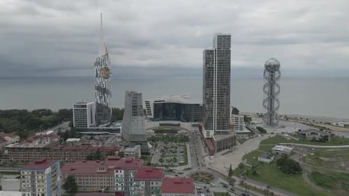 Aerial shot of alphabetic tower, skyscrapers and embankment of beautiful city of Batumi, Georgia