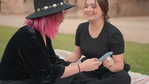 Two Friends With Phone in Park