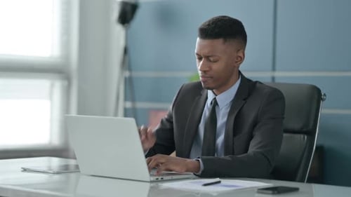 Man Working on Laptop in Office