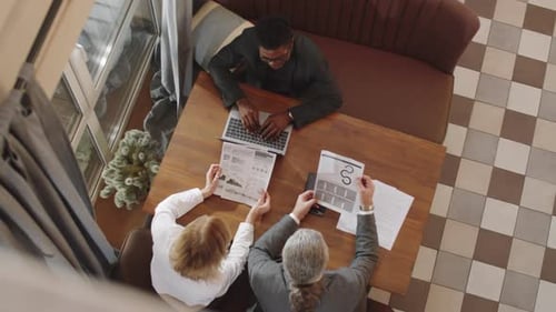 Business Team Discussing Project in Restaurant
