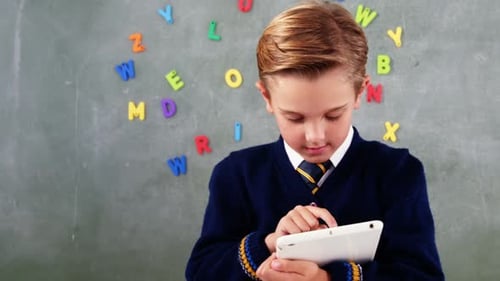 Schoolboy using digital tablet in classroom