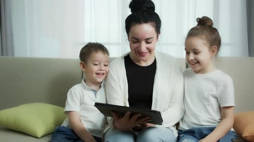 Woman and Children Enjoying a Tablet Together