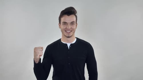 Man Smiling and Raising Fist in Celebration