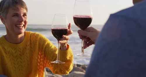 Couple drinking wine by the sea