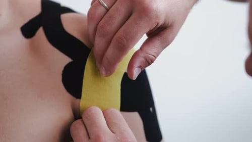 Athletic Tape Applied to Man's Shoulder