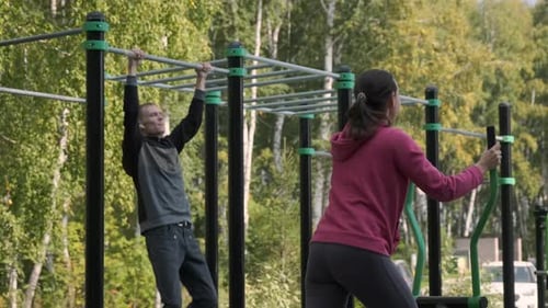 Man and Woman Working Out in an Outdoor Gym