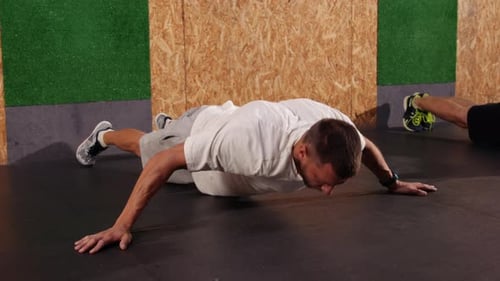 Adults Exercising Doing Push-Ups at the Gym
