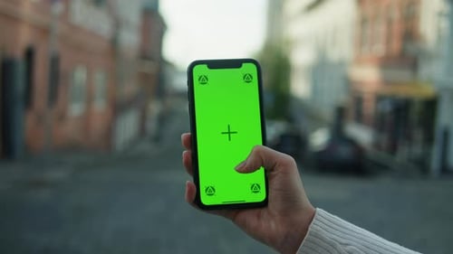 Woman Holding Smartphone with Chroma Key Closeup