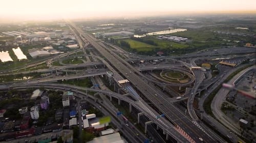 Aerial View of Highway Road Interchange with Busy Urban Traffic Speeding on Road