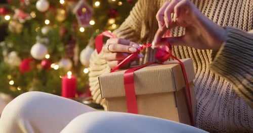 Tying a Festive Christmas Gift Ribbon at Night