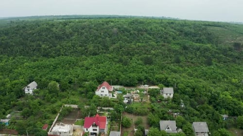 Aerial Footage of Flying Over Residential Rural Area Then Over a Forest
