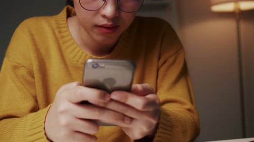Woman with Glasses Using Smartphone at Night