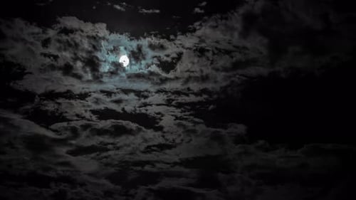 Eerie Clouds Passing Across a Night Sky Moon