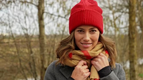 Smiling Woman in Red Hat and Scarf Outdoors