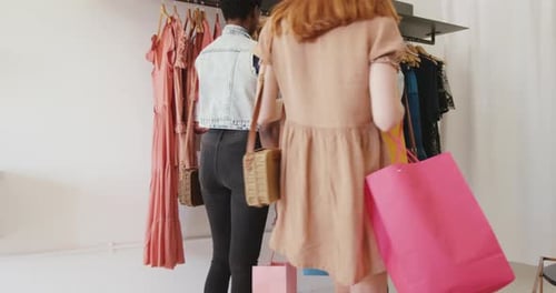 Young adult female friends in a clothes shop