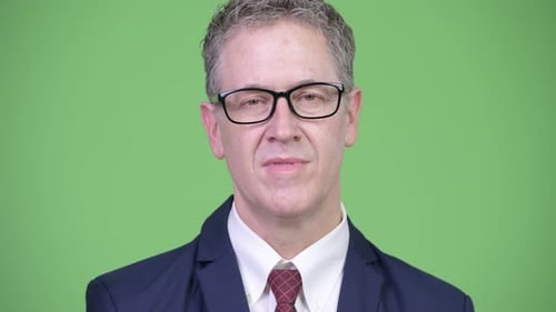 Studio Shot of Happy Mature Businessman Smiling While Wearing Eyeglasses