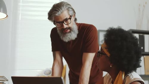 Man and Woman Working Together on a Laptop