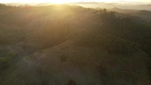 4K aerial view from a drone flying over the valley, fog in the morning.