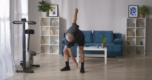 Mature Man Stretching During Home Workout