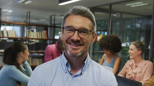 Smiling Man In Modern Open Office Space