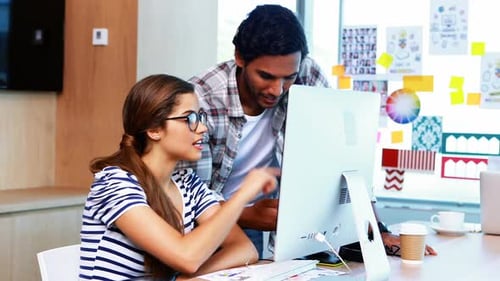 Creative Team Collaborating on a Computer in Office