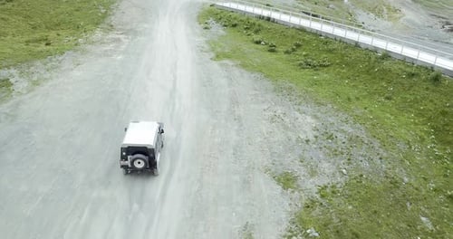 Aerial View of 4X4 Car Driving Off Road Along Mountain Slope
