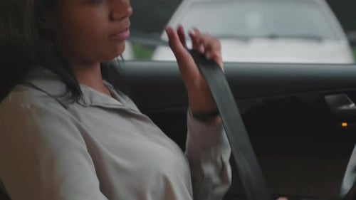 Businesswoman Fastening Seatbelt
