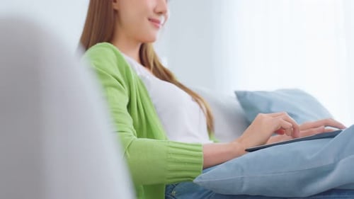 Close up of Asian business woman typing on computer and work at home.