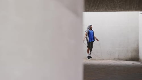 Side view man with prosthetic leg doing skipping rope